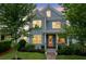 Charming two-story home with blue siding, white trim, and lush landscaping, showcasing curb appeal at 410 Eliston St, Summerville, SC 29486
