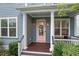 Inviting front porch with classic columns, pink door, and well-maintained landscaping for a welcoming entrance at 410 Eliston St, Summerville, SC 29486