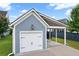 Detached garage with a covered port, new siding and a driveway at 410 Eliston St, Summerville, SC 29486