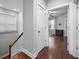 Upstairs hallway with hardwood floors leading into a bedroom and staircase at 410 Eliston St, Summerville, SC 29486