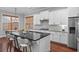 Kitchen with stainless steel appliances, a black granite island, wood floors, and white cabinets at 410 Eliston St, Summerville, SC 29486