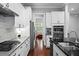 Modern kitchen with stainless appliances, white cabinets, granite countertops, and convenient wall ovens at 410 Eliston St, Summerville, SC 29486