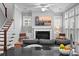 Open concept living room with fireplace and kitchen view; natural light throughout at 410 Eliston St, Summerville, SC 29486