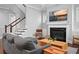 Comfortable living room featuring a fireplace, large television, and access to staircase at 410 Eliston St, Summerville, SC 29486