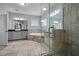 Bright bathroom featuring double sinks, soaking tub, and glass-enclosed shower with a tiled surround at 410 Eliston St, Summerville, SC 29486