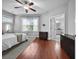 Spacious main bedroom with hardwood floors, a ceiling fan, and a view into the ensuite bathroom at 410 Eliston St, Summerville, SC 29486