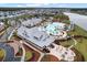 Aerial view of the community pool area, featuring pools, clubhouse, lounge chairs, and beautifully landscaped grounds at 410 Eliston St, Summerville, SC 29486