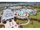 Aerial view of the community pool area with palm trees, lounge chairs, and a fire pit with seating at 410 Eliston St, Summerville, SC 29486