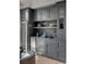 Chic bar area with gray cabinetry, a wine fridge, shelves with barware, and marble countertops offers a sophisticated design at 507 Mccants Dr, Mount Pleasant, SC 29464