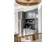 Stylish bar area featuring a wine fridge, gray cabinetry, marble counters, and glass shelves creates an inviting entertaining space at 507 Mccants Dr, Mount Pleasant, SC 29464