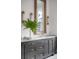 Modern bathroom featuring stylish vanity with double sinks, marble countertop, and decorative palm leaf, offering spa-like ambiance at 507 Mccants Dr, Mount Pleasant, SC 29464