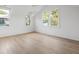 Bright bedroom featuring hardwood floors, white walls, and large windows at 507 Mccants Dr, Mount Pleasant, SC 29464