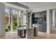 Modern dining area with a glass table, comfortable chairs, a built-in bar, and large windows at 507 Mccants Dr, Mount Pleasant, SC 29464