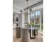 Bright dining room with glass table, stylish chairs, modern chandelier, and large windows overlooking lush greenery at 507 Mccants Dr, Mount Pleasant, SC 29464