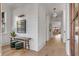 Charming hallway with light hardwood floors, a shiplap accent wall, a rustic bench, and elegant lighting fixtures at 507 Mccants Dr, Mount Pleasant, SC 29464