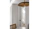 Bright hallway leading to a staircase and doorway, lit by modern light fixture at 507 Mccants Dr, Mount Pleasant, SC 29464