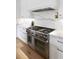 Modern kitchen boasts stainless steel range, marble countertops, and white cabinetry, creating a sleek and functional design at 507 Mccants Dr, Mount Pleasant, SC 29464