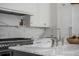 Close-up of a kitchen with marble countertops, stainless steel appliances, and custom cabinets at 507 Mccants Dr, Mount Pleasant, SC 29464
