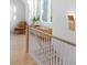 Sunlit landing showcases a wooden console table, accent chair, and large window creating an inviting space at 507 Mccants Dr, Mount Pleasant, SC 29464