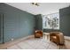 A comfortable living room features custom wall paneling, two leather chairs, and natural light from a large window at 507 Mccants Dr, Mount Pleasant, SC 29464