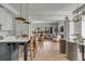 Open-concept living space with kitchen island seating, a comfortable couch, and a cozy fireplace at 507 Mccants Dr, Mount Pleasant, SC 29464