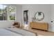 Charming main bedroom with a stylish accent chair, modern wood dresser, and natural light streaming in through the windows at 507 Mccants Dr, Mount Pleasant, SC 29464