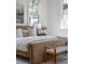 Elegant main bedroom with large windows, a cozy bench, and soft, neutral tones for a relaxing and inviting space at 507 Mccants Dr, Mount Pleasant, SC 29464
