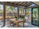 Inviting outdoor patio features a dining table with seating, stainless steel grill, and lush landscaping with palm trees near the pool at 507 Mccants Dr, Mount Pleasant, SC 29464