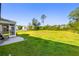 Spacious backyard with well-maintained lawn and a screened porch with seating at 5115 Cranesbill Way, Johns Island, SC 29455