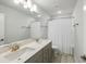 Bathroom featuring dual sinks, quartz countertop, and a framed mirror with a shower and tub combo at 5115 Cranesbill Way, Johns Island, SC 29455