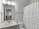 Clean bathroom with quartz countertops, white cabinets and a shower at 5115 Cranesbill Way, Johns Island, SC 29455
