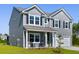 Charming two-story home with gray siding, black shutters, and a well-manicured front lawn at 5115 Cranesbill Way, Johns Island, SC 29455