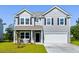 Charming two-story home with gray siding, black shutters, and a two-car garage at 5115 Cranesbill Way, Johns Island, SC 29455