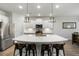 Elegant kitchen with white cabinets, quartz countertops, a center island and stainless steel appliances at 5115 Cranesbill Way, Johns Island, SC 29455