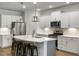 Well-lit kitchen featuring white cabinets, stainless steel appliances, and stylish pendant lights above the island at 5115 Cranesbill Way, Johns Island, SC 29455