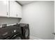Laundry room showcasing side-by-side Samsung washer and dryer and built-in cabinetry at 5115 Cranesbill Way, Johns Island, SC 29455