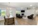 Spacious living room featuring a fireplace, leather sofas, and open access to a dining area at 5115 Cranesbill Way, Johns Island, SC 29455