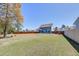 Expansive backyard showcasing the home's exterior and a spacious lawn at 5525 Alpine Dr, Summerville, SC 29483
