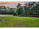 Large, well-maintained backyard with mature trees and a wooden fence at 5525 Alpine Dr, Summerville, SC 29483
