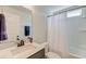 Bright bathroom featuring a clean vanity sink, mirror, and a white shower curtain at 5525 Alpine Dr, Summerville, SC 29483