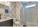The bathroom has floral wallpaper, single vanity, bathtub, and a shower at 5525 Alpine Dr, Summerville, SC 29483