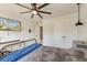 Well lit bedroom featuring a fan, a bed with a blue blanket, and a mounted television at 5525 Alpine Dr, Summerville, SC 29483
