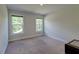This bedroom has neutral walls, two windows, and carpeted floors at 5525 Alpine Dr, Summerville, SC 29483