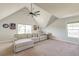 Spacious bonus room features a vaulted ceiling, a comfortable couch, and lots of natural light at 5525 Alpine Dr, Summerville, SC 29483