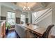 Bright dining room with coffered ceilings, stylish chandelier, and large windows overlooking the landscape at 5525 Alpine Dr, Summerville, SC 29483