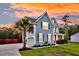 Charming two-story home with a well-manicured lawn and mature landscaping at 5525 Alpine Dr, Summerville, SC 29483