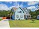 Charming two-story blue house with lush landscaping and a spacious front yard at 5525 Alpine Dr, Summerville, SC 29483