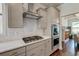 Modern kitchen features white cabinets, stainless steel appliances, and a view into the dining area at 5525 Alpine Dr, Summerville, SC 29483