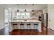 Large kitchen island offers seating and workspace, with stainless steel appliances and modern fixtures at 5525 Alpine Dr, Summerville, SC 29483