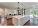 Open-concept kitchen with large island, stainless steel appliances, and seamless flow to the living room at 5525 Alpine Dr, Summerville, SC 29483